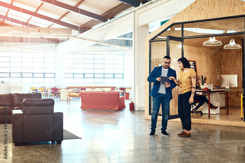Aufkleber its a big space to get creative. shot of two designers working on a digital tablet together in an of