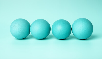 Blue dyed Easter eggs on mint background. Celebration of Christian feast concept. High quality photo