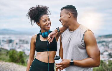 Living well leads to true happiness. Shot of a sporty young couple taking a break while exercising...