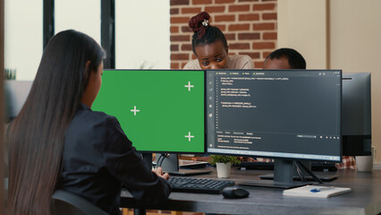 Software developer writing algorithm in front of computer with green screen chroma key mockup in ai...