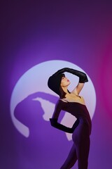 Portrait of a charming lady posing on stage spotlight silhouette disco color background unaltered