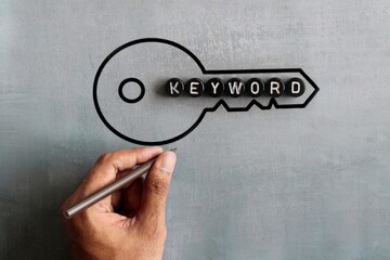 Text KEYWORD and drawing image of key. Search engine optimization, web search concept.