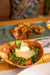 Arugula tomato salad with shaved parmesan cheese