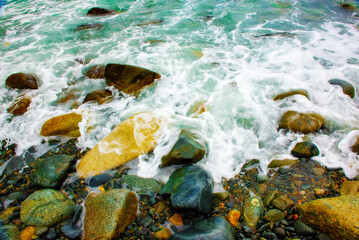 coastline, beautiful beach stones and blue waves. lots of sun and beautiful nature.