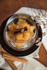 Caramelized apple dessert on wooden table. Baked or roast apple with cinnamon.