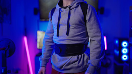 Headless male gamer in sweater wearing posture belt in cyberspace background
