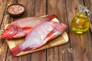 Two raw tilapias ready to be cooked.