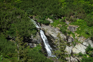 Beautiful small waterfall on top of the mountains. Amazing landscape around the world.