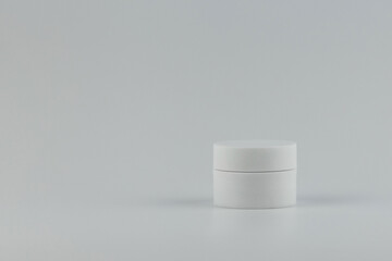 Skincare and cosmetology mockup with copy space. Unbranded white plastic jar for cosmetics products. Branding identity template for your text and design