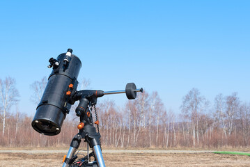 Black telescope on a tripod at the observatory for observation of stars and planets. Science, astronomy concept