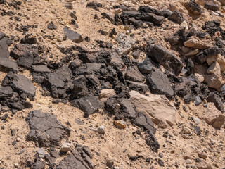 Repair of asphalt pavement. Old gray asphalt piled high. Background.