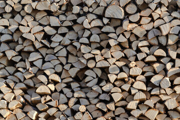 Stack of wood prepared for winter. Chopped wood background