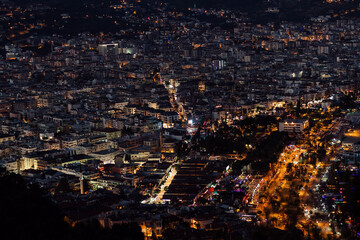 Alanya, Turkey - July 2021: Night view on The Alanya city, buildings and mountains with many city lights