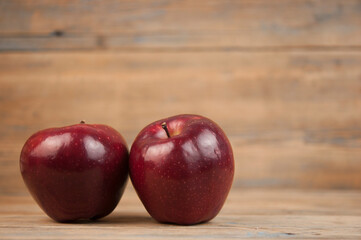 Two Bright Red and Ready to eat  Apple in Rustic Barn Setting with Old Wood Boards and room or space for copy, text, your words.
