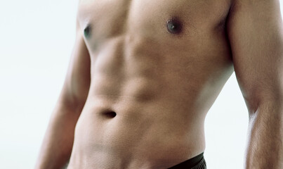 Abs worthy of a second glance. Cropped shot of an unidentifiable young mans abdominal muscles.