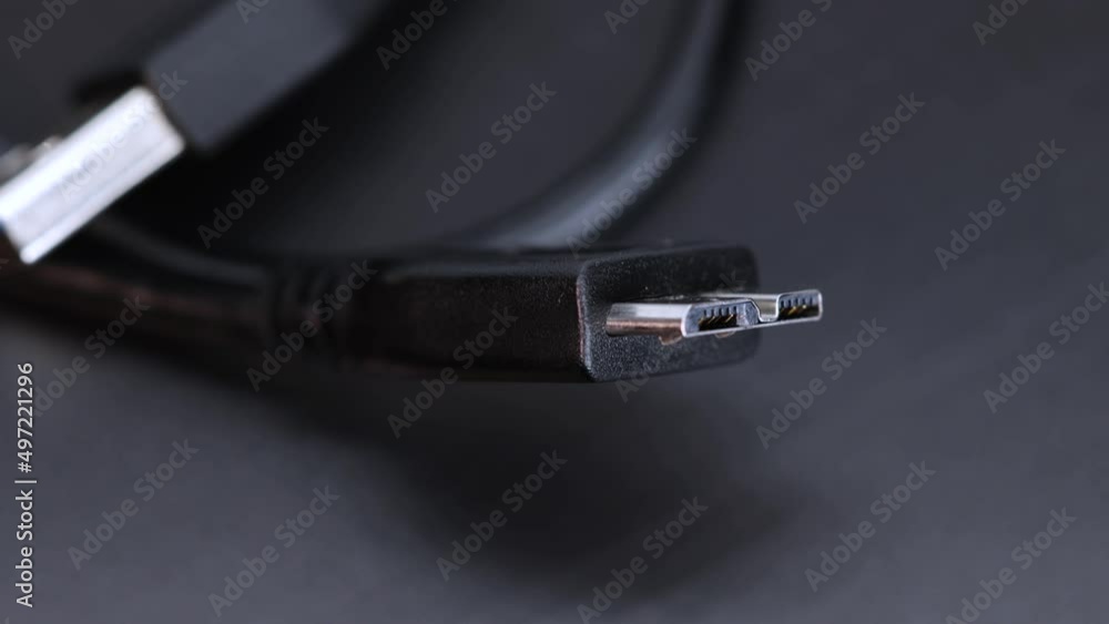 Poster hard disk ssd wire plug connector, black background macro shot close up view in 4k rotating motion.