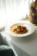 Tagliatelle pasta with salmon, baked tomato and parmesan cheese