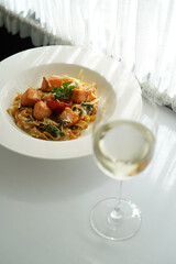 Tagliatelle pasta with salmon, baked tomato and parmesan cheese