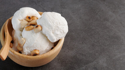 cold coconut milk ice cream summer dessert, bowl on wooden floor