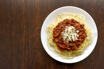 Spaghetti Bolognese with minced beef, onion, chopped tomato, garlic, olive oil, stock cube, tomato puree and Italian herb. Traditional Italian food on a plate.	
