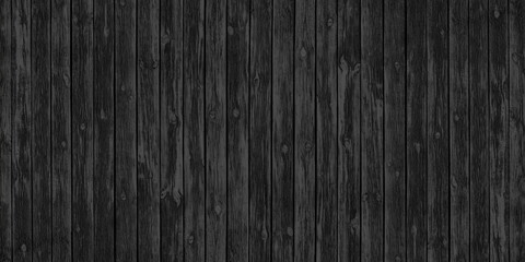 Old black knotty wooden board wide texture. Dark gray rough wood plank backdrop. Abstract large panoramic background