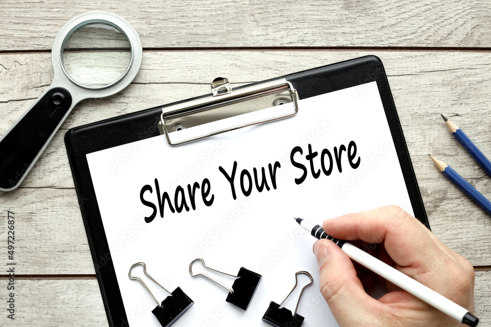 Poster share your store. clip folder on the table with place for text. a man writes a text. business concep