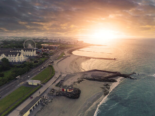 Aerial view on sunrise scene over Galway city, Ireland. Popular Salthill area with beach, hotels and high value property of the town. Dark and moody sky. Sun flare. Cinematic look © mark_gusev