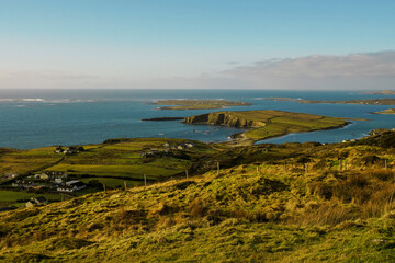 Beautiful nature scene of Sky Road in county Galway, near Clifden town. Ireland. Green hills and blue ocean water. Cloudy sky. Irish landscape.