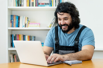 Handsome handyman with beard working at computer