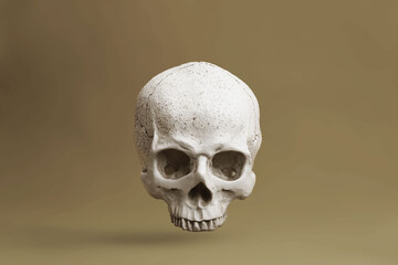 Human skull floating on light brown background. Life and death concept.
