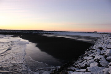 Ocean Shore in sunset surrounded by snow and ice