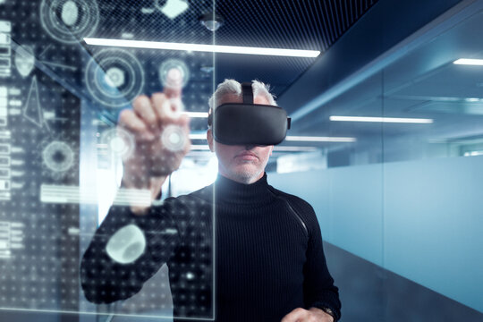 Senior man in virtual reality headset using advanced technology