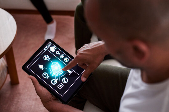 Man using smart home application on tablet