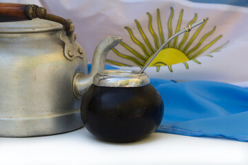 a mate and a kettle with the Argentine flag