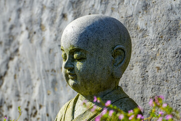 A stone sculpture of a child monk