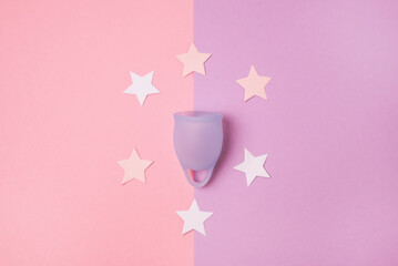 Menstrual Cup and White Confetti in Shape of Stars on Pink Background Alternative Feminine Hygiene Product During the Period Women health concept