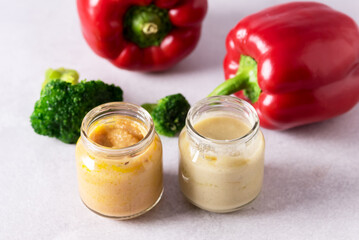 Glass Jars with Natural Baby Food on the Light Gray Background Vegetable Puree with Broccoli and Red Pepper