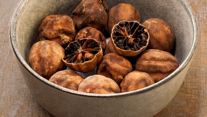 Persian dried whole limes (limu omani) in bowl.