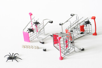 Broken carts from the supermarket next to the inscription crisis and black spiders. White background. Economic, financial and consumer crises. Rising prices and low purchasing power