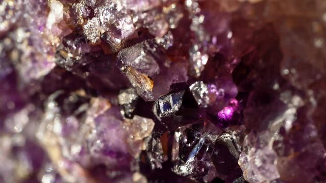 extreme close-up of purple crystals on a stone