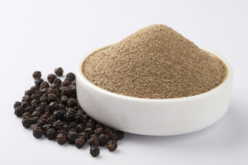 Indian spices - black pepper powder,Black pepper corns scattered on white background and Black pepper Powder on Glass bowl isolated on white background.