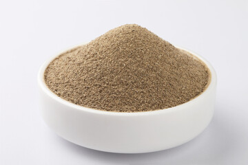 Indian spices - black pepper powder,Black pepper corns scattered on white background and Black pepper Powder on Glass bowl isolated on white background.
