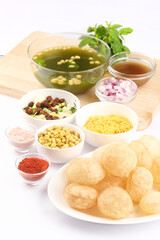 Fototapeta na wymiar Panipuri or Golgappa is a popular street snack from India. It's a round, hollow puri filled with a mixture of flavoured water and other chat items