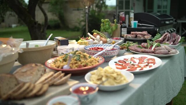 Party table packed with fresh delicious food for a BBQ