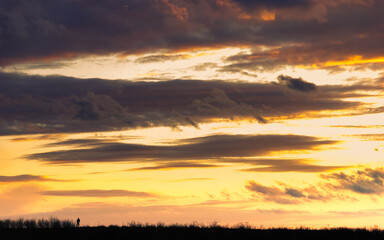 Dramatic sunset with man on horizon