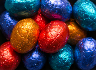 Close-up of small chocolate Easter eggs wrapped in colored foil