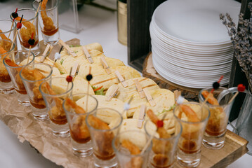 Assorted different types of cheese on a wooden board.