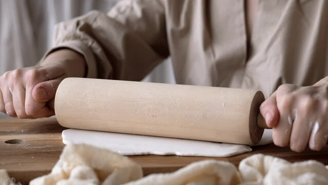 Handcraft woman master modeling cold porcelain, hands with rolling pin, creative workshop, Girl sculpts from porcelain, hobby for the soul scandinavian and boho style interior decor