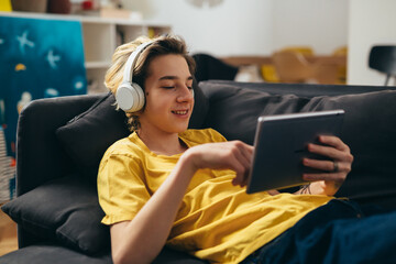 teenager using digital tablet at home