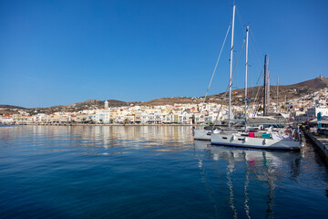 Fototapeta na wymiar Ermoupoli Syros island Cyclades, Greece. Moored yacht, waterfront building, sunny day, blue sky